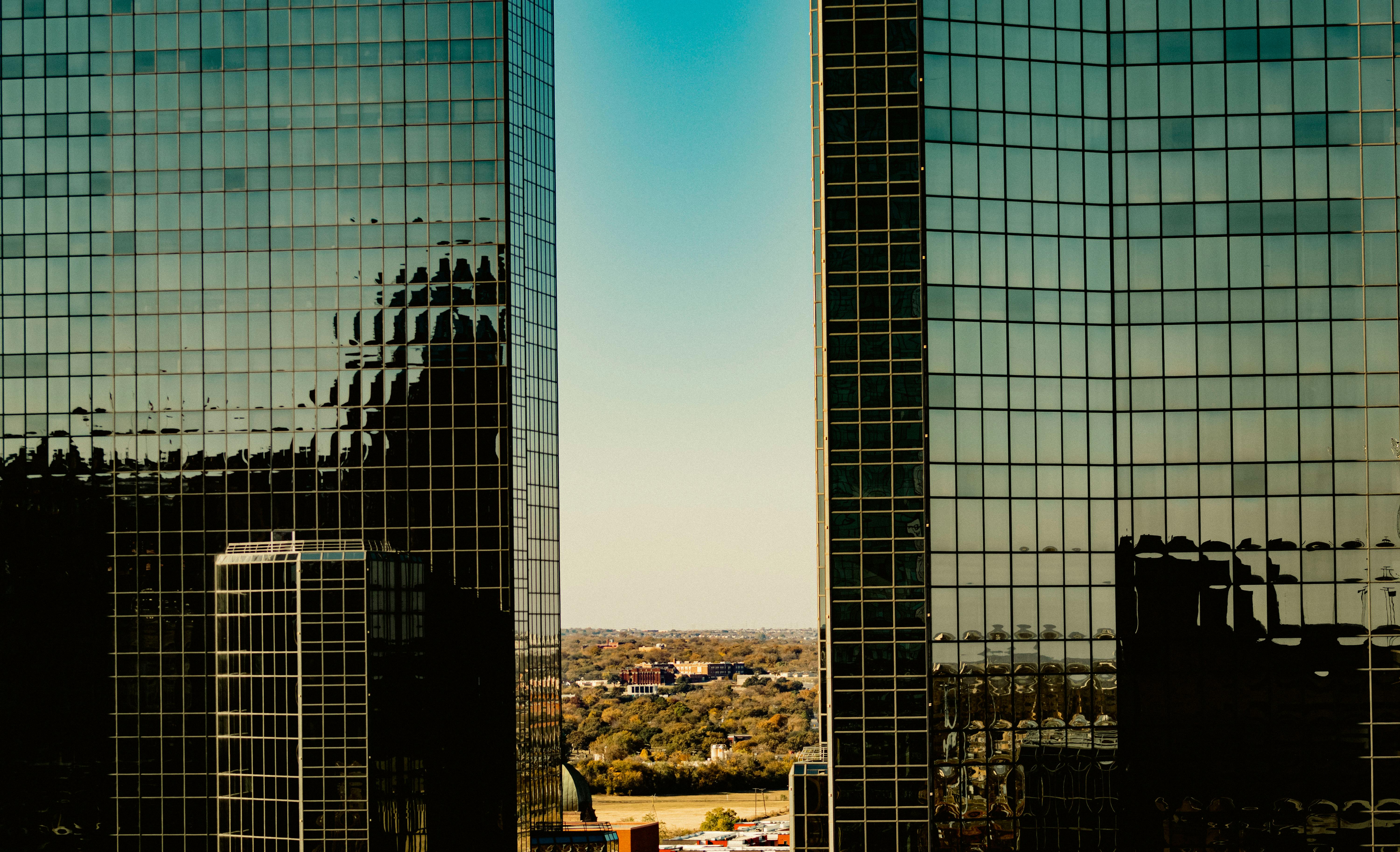 A view of modern glass skyscrapers in Fort Worth, Texas, reflecting the skyline.